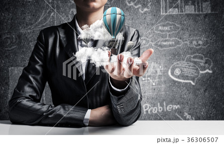 Woman presenting flying balloon in hand. 36306507
