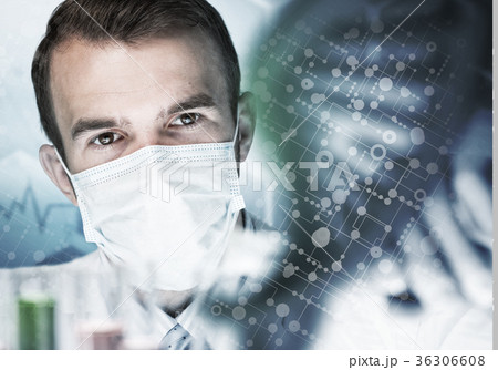 Young scientist mixing reagents in glass flask in clinical laboratory Young scientist mixing reagents in glass flask in clinical laboratory 36306608