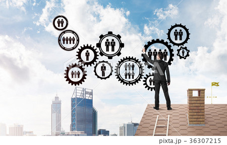 Businessman on house roof presenting teamwork and connection concept. Mixed media 36307215