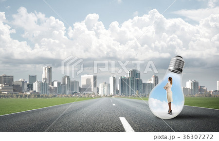 Businesswoman inside light bulb Businesswoman inside light bulb 36307272