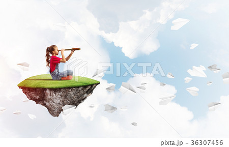 Concept of careless happy childhood with girl looking in spyglass Concept of careless happy childhood with girl looking in spyglass 36307456