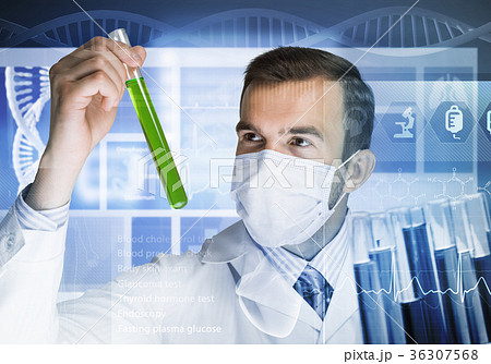 Portrait of concentrated male scientist working with reagents in laboratory Portrait of concentrated male scientist working with reagents in laboratory 36307568
