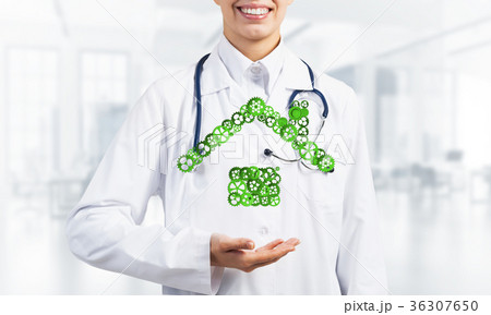Symbol of homepage or accomodation made with cogwheels presented in female palms 36307650