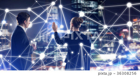 Concept of social connection and networking against night city view and partners working in cooperation 36308256