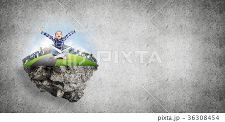 Cute girl of school age with book exploring this great world 36308454