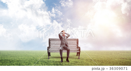 Young man in suit in park dont want to hear anything 36309071