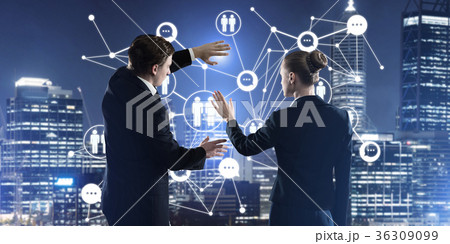 Concept of social connection and networking against night city view and partners working in cooperation 36309099