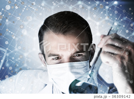 Portrait of concentrated male scientist working with reagents in laboratory 36309142