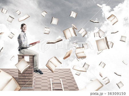 Man reading book and many of them flying in air 36309150