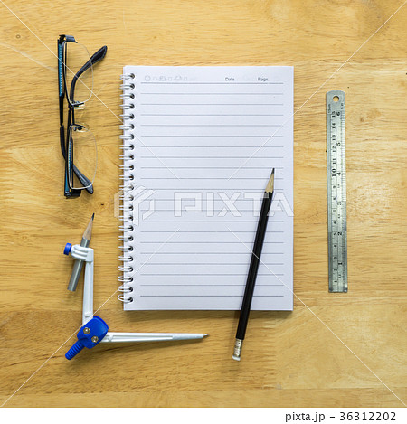 Pencil with paper and book on wooden table 36312202