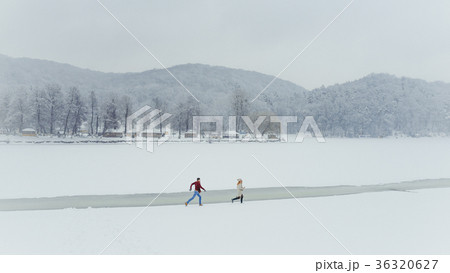 Loving Couple Having Fun Running Snowy Meadow 36320627