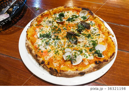 Freshly baked Italian pizza from wood flame oven Freshly baked Italian pizza from wood flame oven 36321198