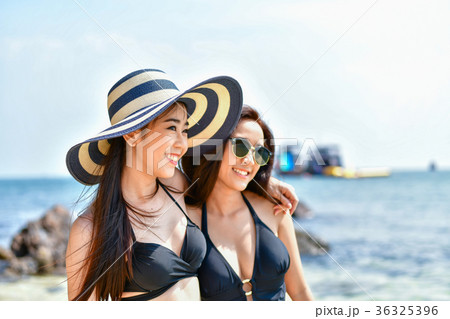 Beautiful woman wearing a swimsuit playing in the beach. 36325396