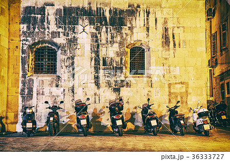 Motorbike parking near wall of Trogir cathedral Motorbike parking near wall of Trogir cathedral 36333727