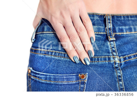 Young girl in jeans with blue manicure 36336856