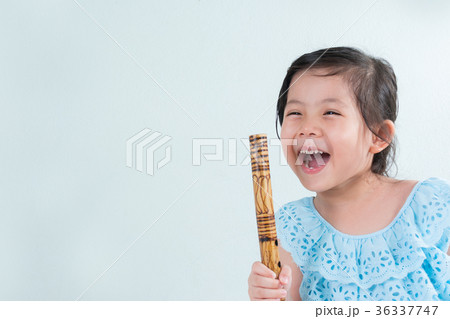 Thai Little Cute Girl in Traditional Dress Playing Thai Bamboo F Thai Little Cute Girl in Traditional Dress Playing Thai Bamboo F 36337747