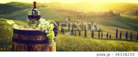 Red wine bottle and wine glass on wodden barrel. Red wine bottle and wine glass on wodden barrel. 36338250