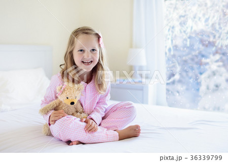 Kid in bed. Winter window. Child at home by snow. 36339799