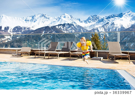 Child in outdoor swimming pool of alpine resort Child in outdoor swimming pool of alpine resort 36339967