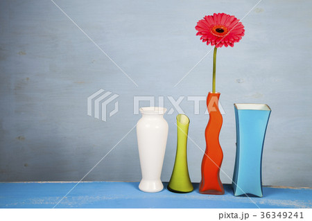 Multicolored vases and pink gerbera 36349241