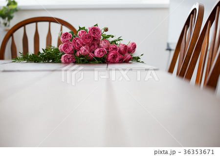 Picture of room with white table, bouquet 36353671