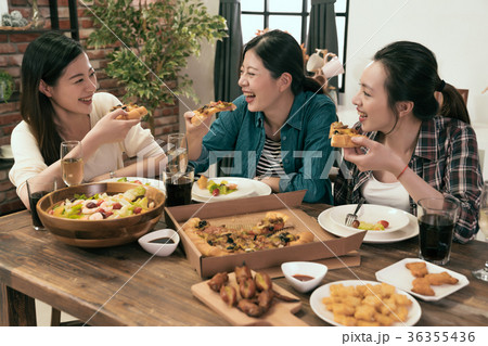 people enjoys pizza together at home people enjoys pizza together at home 36355436