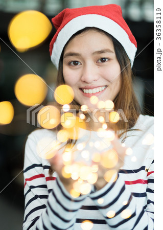smiling asia woman holding party string lights smiling asia woman holding party string lights 36358119