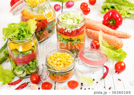 Colorful vegetables in glass jars  36360169