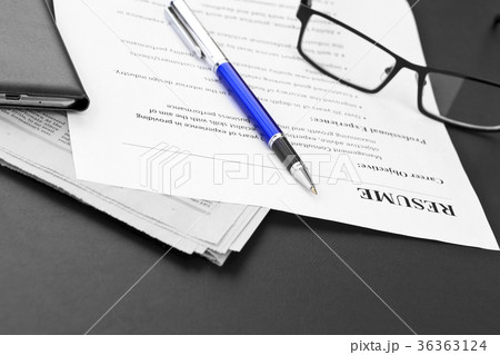 Closeup of resume with pen and glasses on the tabl 36363124