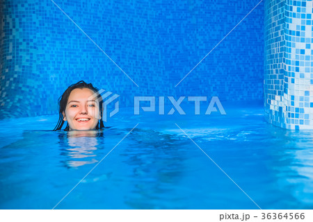 A young smiling girl swimming in the pool with A young smiling girl swimming in the pool with 36364566