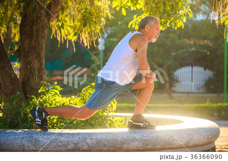 Man Does Morning Exercises Squats on Knee Man Does Morning Exercises Squats on Knee 36366090