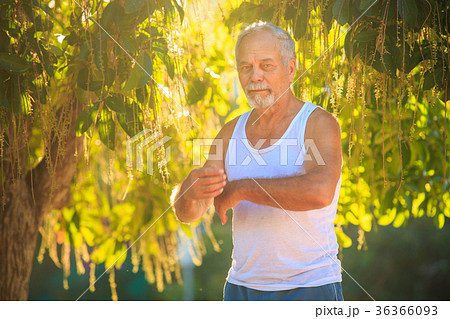 Man Does Morning Exercises Squats on Knee 36366093