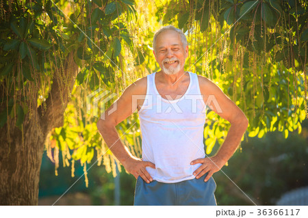 Grey Old Man in Vest Stands Smiles against Tree Grey Old Man in Vest Stands Smiles against Tree 36366117