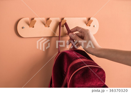 Metal orange hanger with red backpack Metal orange hanger with red backpack 36370320