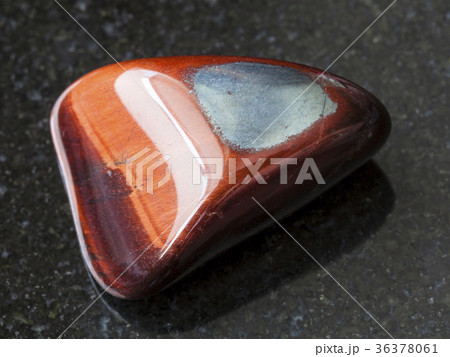 polished Ox's eye gemstone on dark background polished Ox's eye gemstone on dark background 36378061