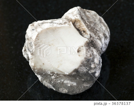rough cacholong stone on dark background 36378137