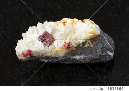 crystal of Cinnabar in Carbonatite stone on dark 36378644