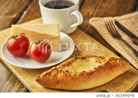 Cheese pie with tomatoes and cup of steaming tea Cheese pie with tomatoes and cup of steaming tea 36384048