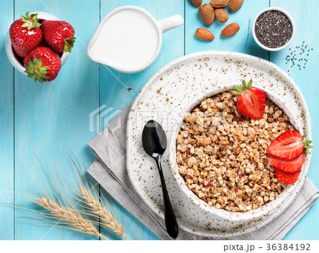 bowl with muesli, fresh strowberry, nuts, chia 36384192