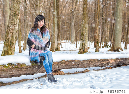 young beautiful woman walking under a snowfall young beautiful woman walking under a snowfall 36386741