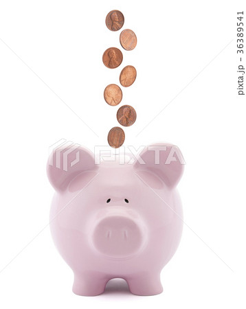 Piggy bank with coins falling into slot Piggy bank with coins falling into slot 36389541