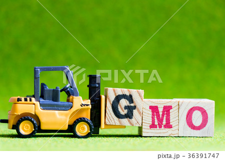 Toy forklift hold letter G to fulfill word GMO 36391747