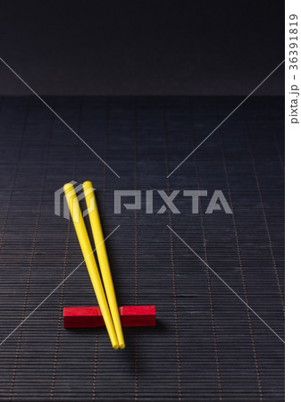 Sushi chopsticks on black bamboo straw mat Sushi chopsticks on black bamboo straw mat 36391819