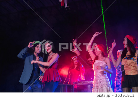 Teenagers are celebrating at the night party. Teenagers are celebrating at the night party. 36391913