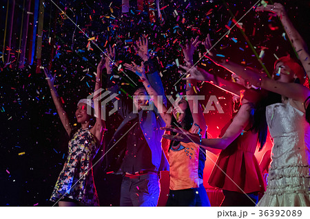 Teenagers are celebrating at the night party. 36392089