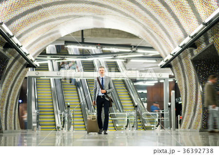 Businessman in front of escalators on a metro 36392738