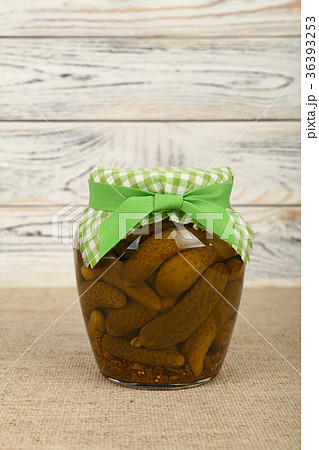 Jar of pickled small gherkin cucumbers on table Jar of pickled small gherkin cucumbers on table 36393253
