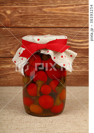 Jar of pickled red hot chili peppers on table Jar of pickled red hot chili peppers on table 36393254