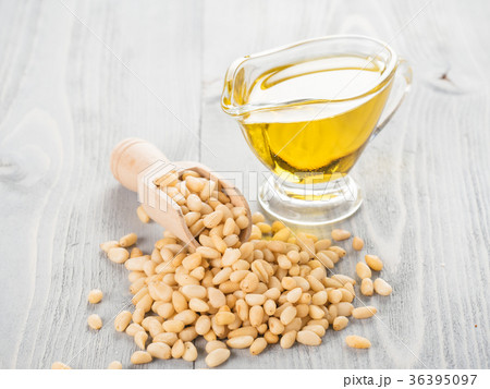 Pine nut oil and pine nuts on gray wooden 36395097