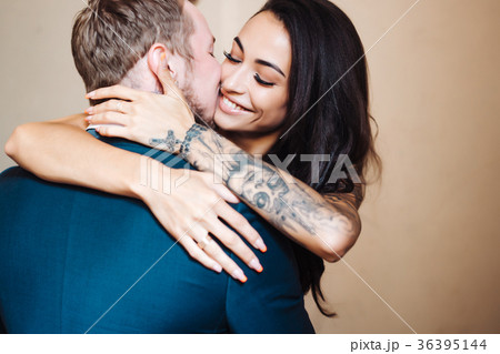 Beautiful, young couple posing on camera indoors Beautiful, young couple posing on camera indoors 36395144